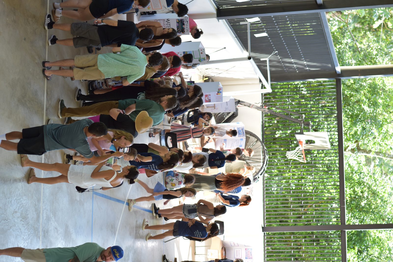 Diverse group of students gathered in bright classroom with solar panels and jungle backdrop visible