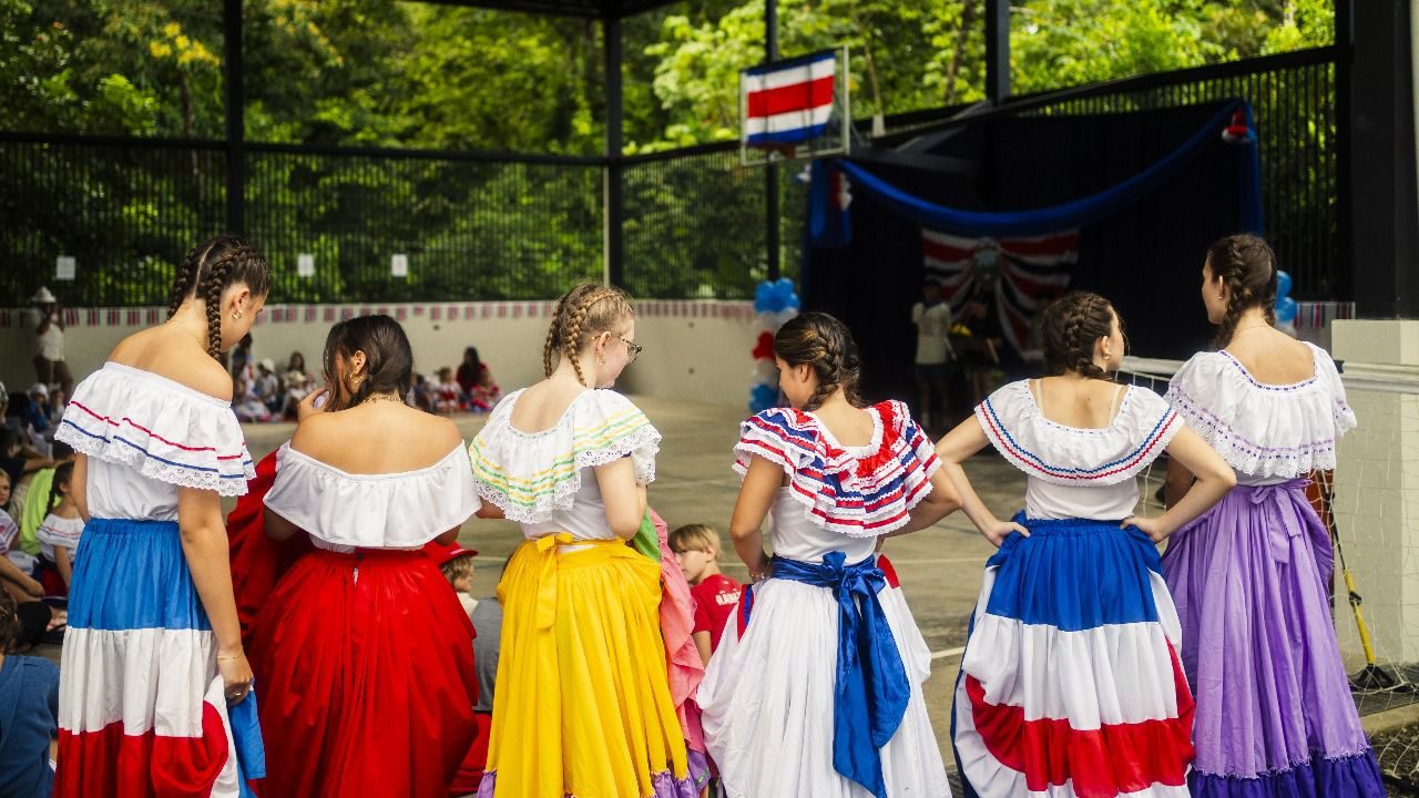 Girls in colorful traditional Costa Rican dress at a school event