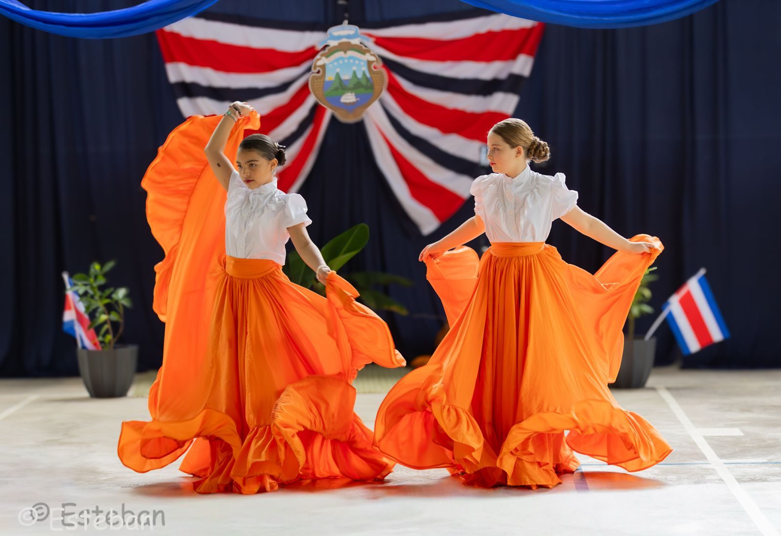Two students perform traditional dance in colorful Costa Rican costumes