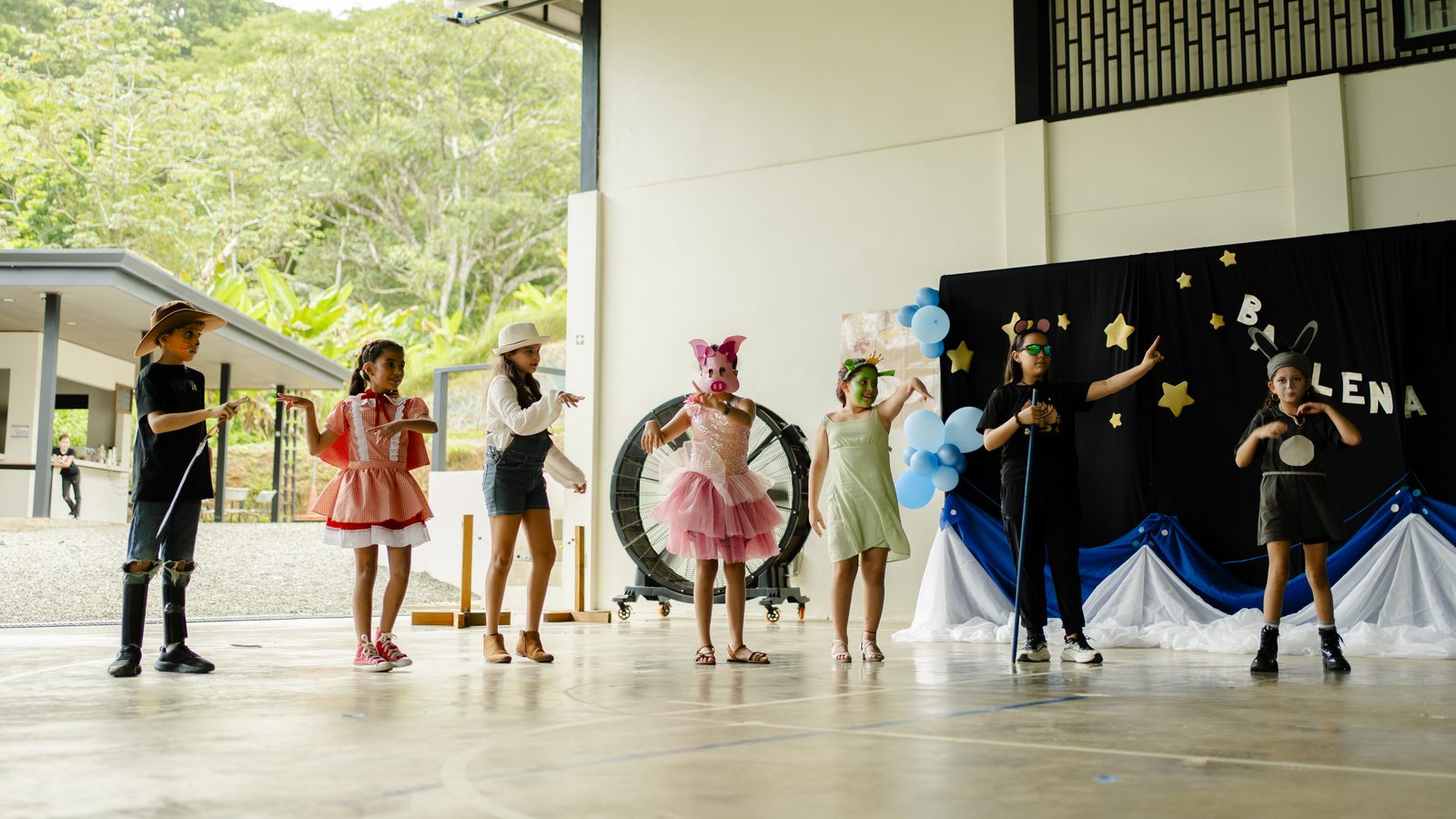 Elementary students perform theatrical production on outdoor school stage